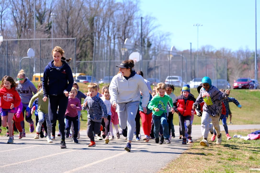 Kids running together with coaches